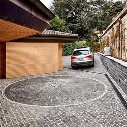 Car driving out of a courtyard